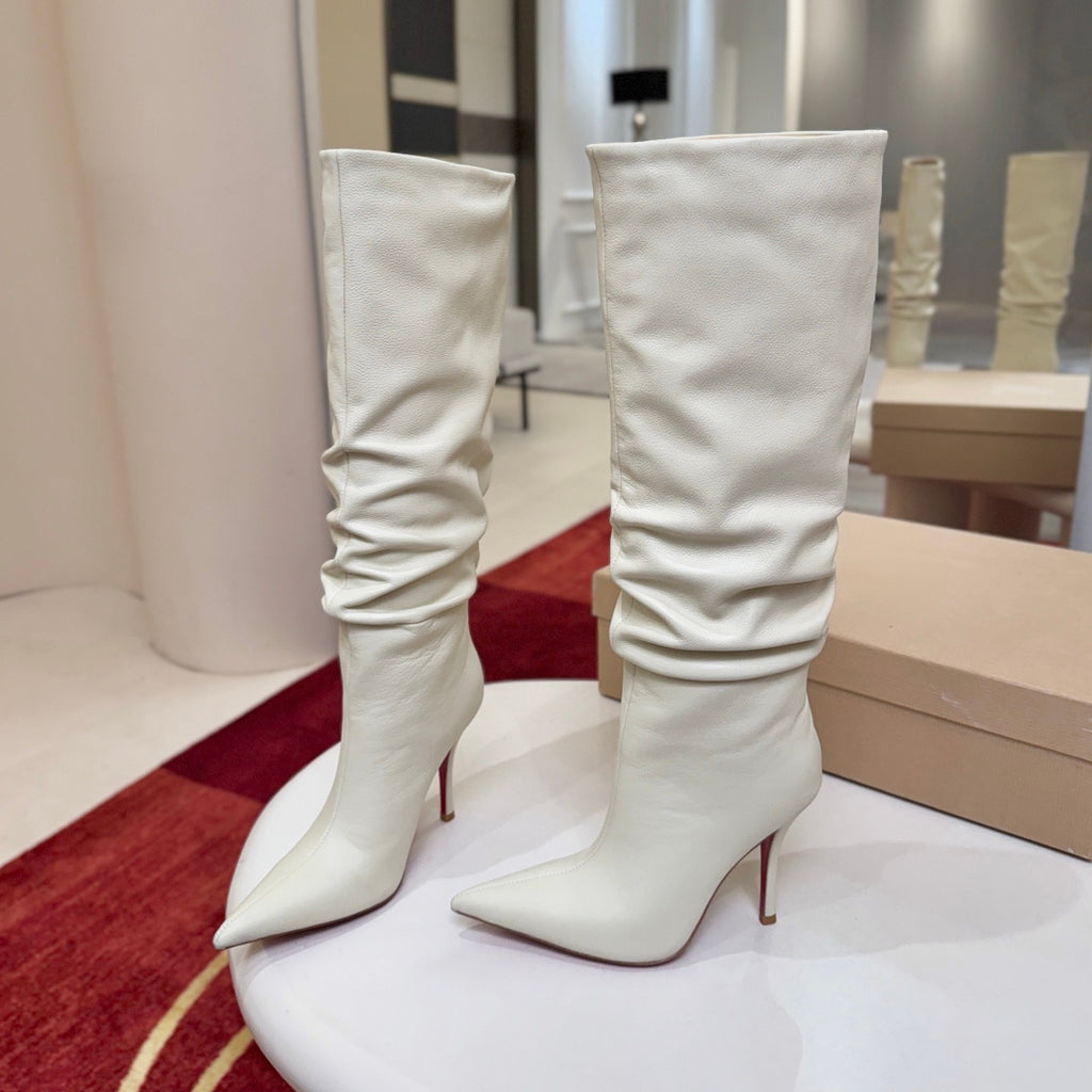 The boot's tapered silhouette creates a refined, modern look. This style features a 100mm stiletto heel.