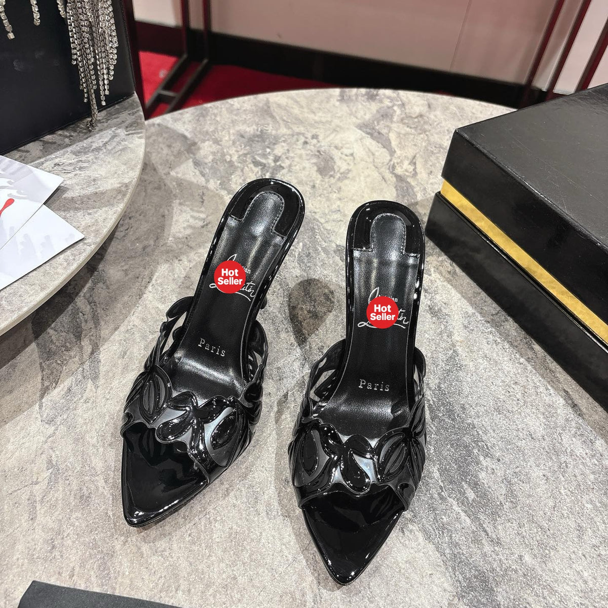 Black high-heeled mules with a stylish cutout design; 10cm heel.