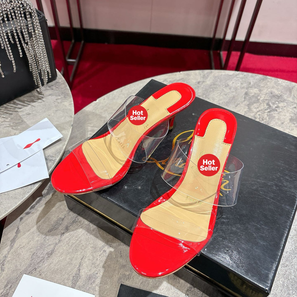 Red translucent high-heeled mules, 8.5cm heel.