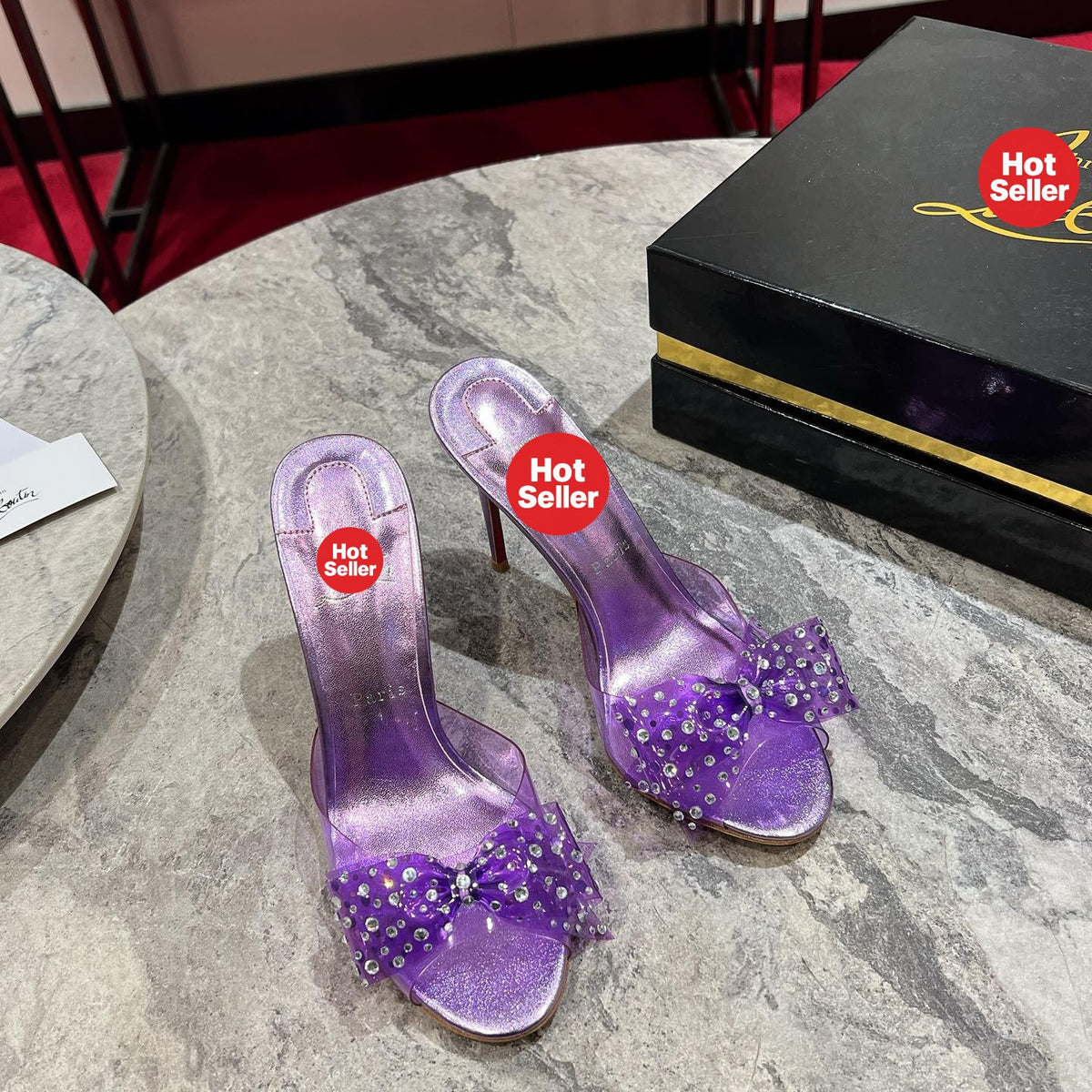 Purple high-heeled slides with a butterfly detail and transparent strap; 10cm heel.