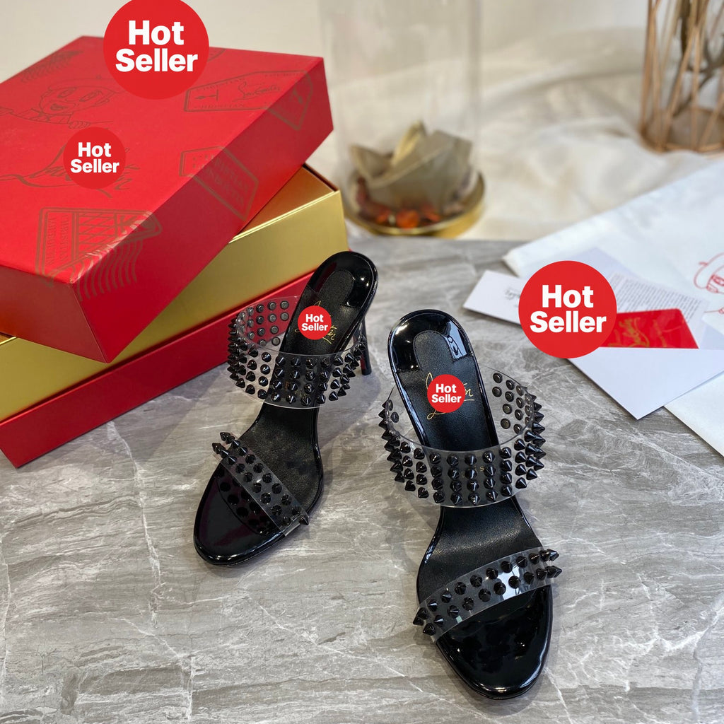 Black high-heeled mules with PVC straps and stud details; 10cm heel.