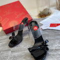 Black high-heeled mules with butterfly-shaped transparent detail; 10cm heel.