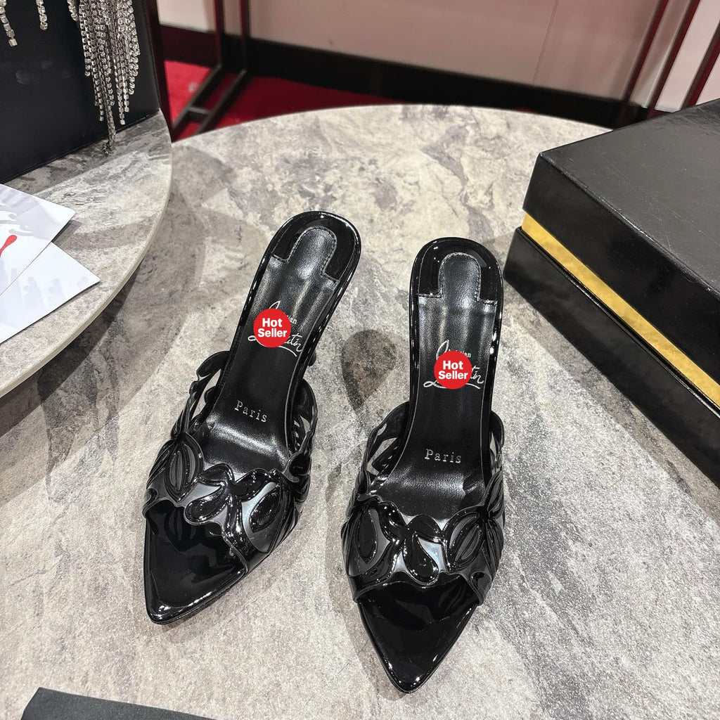 Black high-heeled mules with a stylish cutout design; 10cm heel.