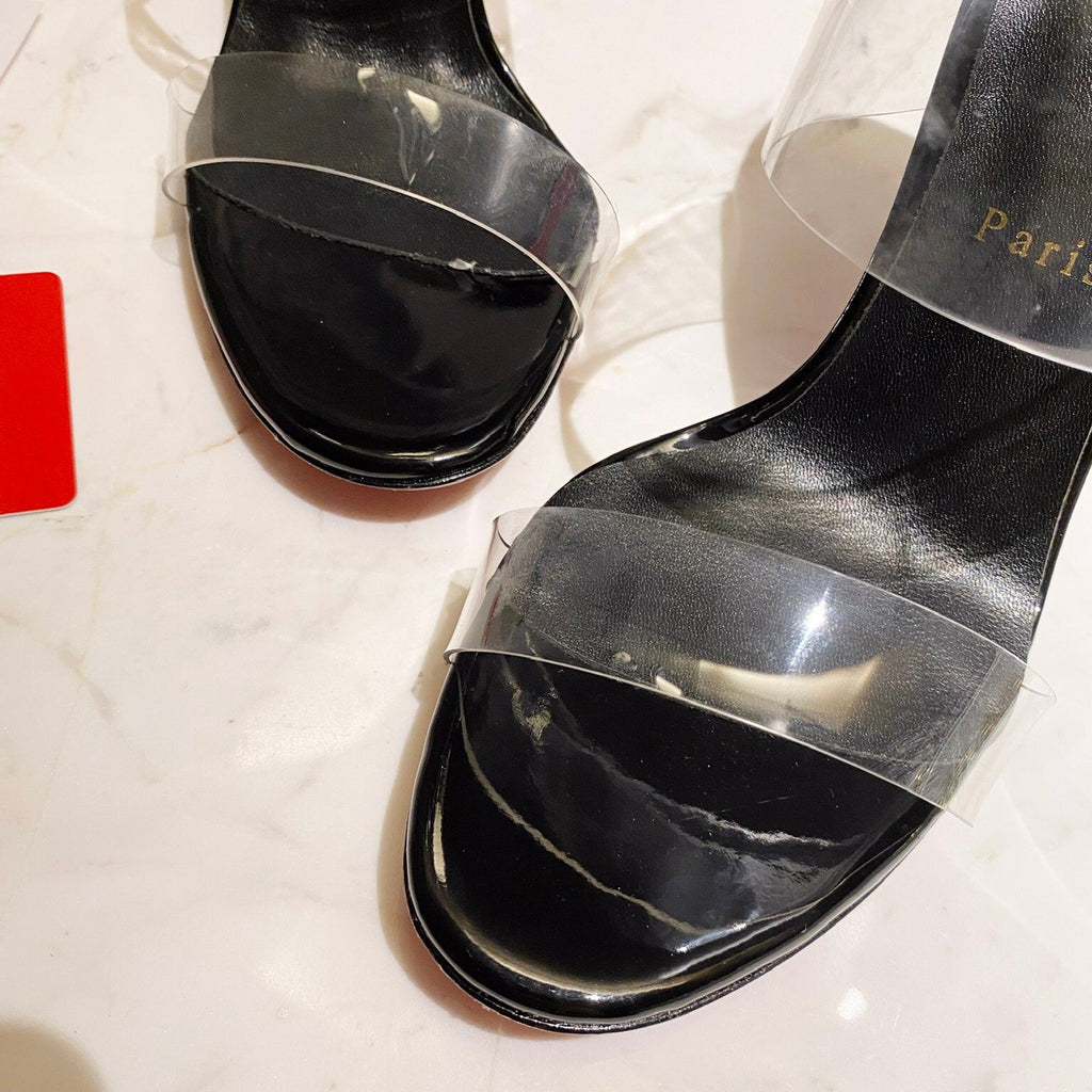 Black high-heeled mules with transparent detailing; 10cm heel.