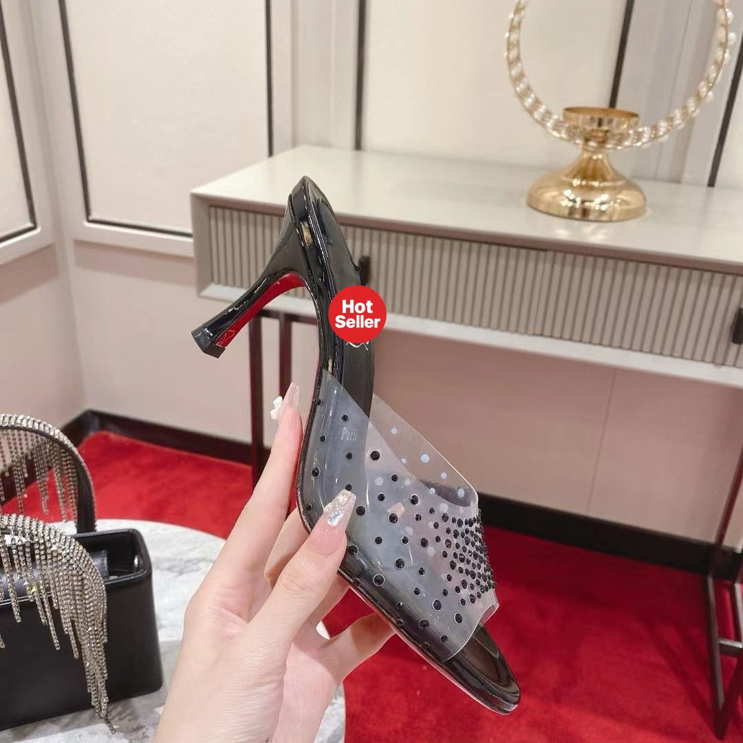 Black open-toe high-heeled mules with transparent strap detail; 8cm heel.