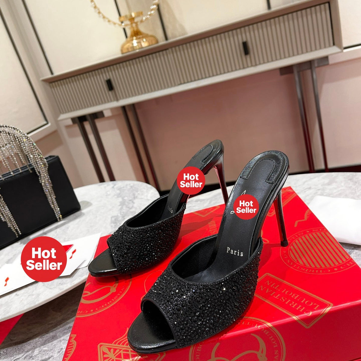 Black peep-toe high-heeled mules with rhinestone embellishment; 10cm heel.