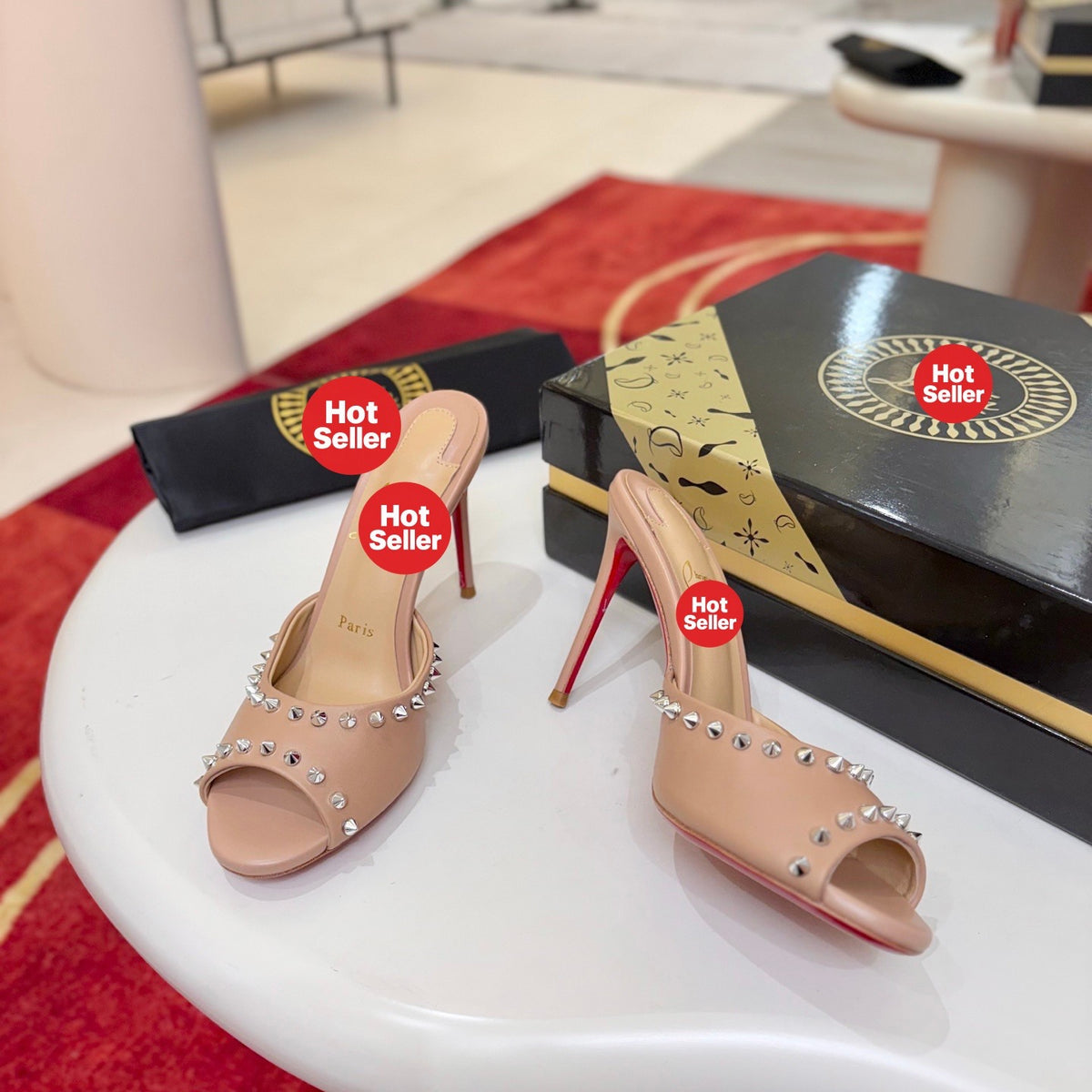 Apricot peep-toe high-heeled mules with stud detailing; 8.5cm heel.