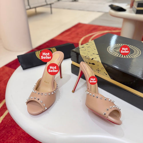 Apricot peep-toe high-heeled mules with stud detailing; 8.5cm heel.