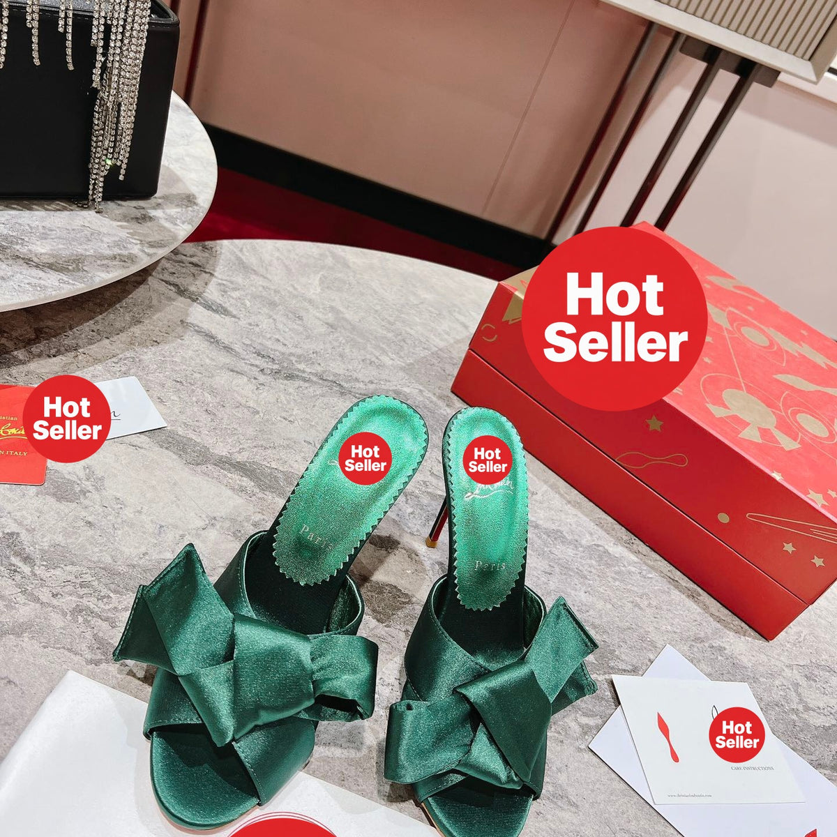 Green high-heeled mules with butterfly-style detail; heel height: 8.5 cm.
