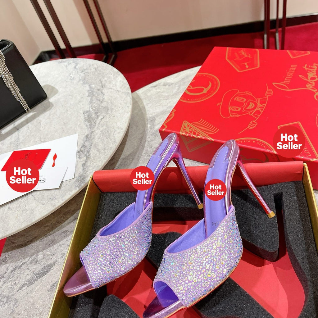 Purple peep-toe high-heeled mules with rhinestone embellishment; 10cm heel.