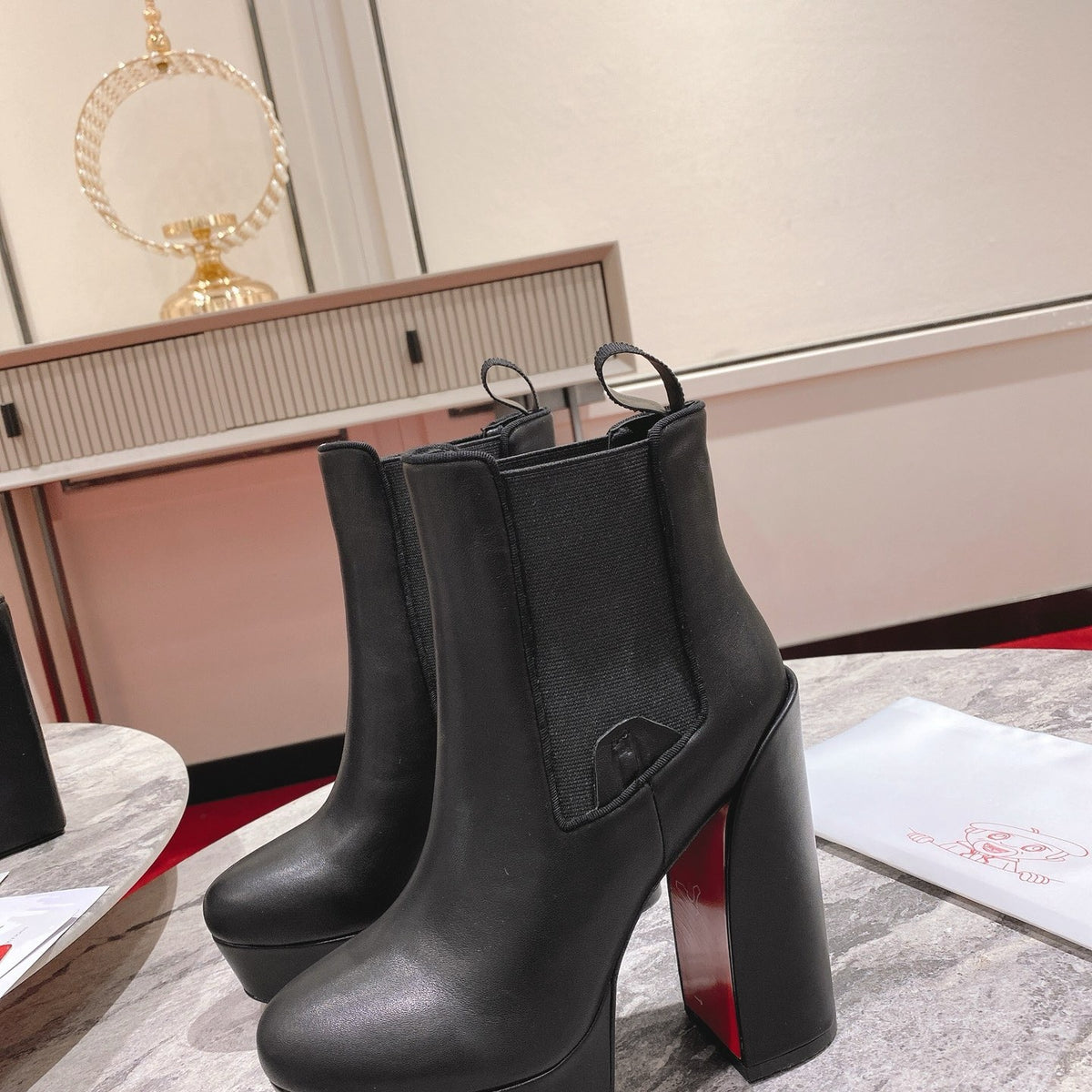 Black calfskin ankle boots with 13cm stiletto heels.
