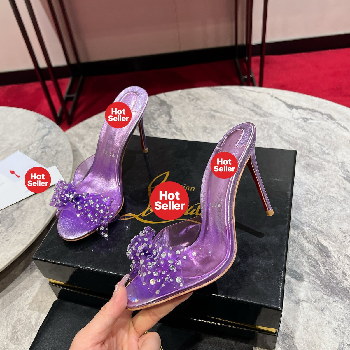 Purple high-heeled slides with a butterfly detail and transparent strap; 10cm heel.