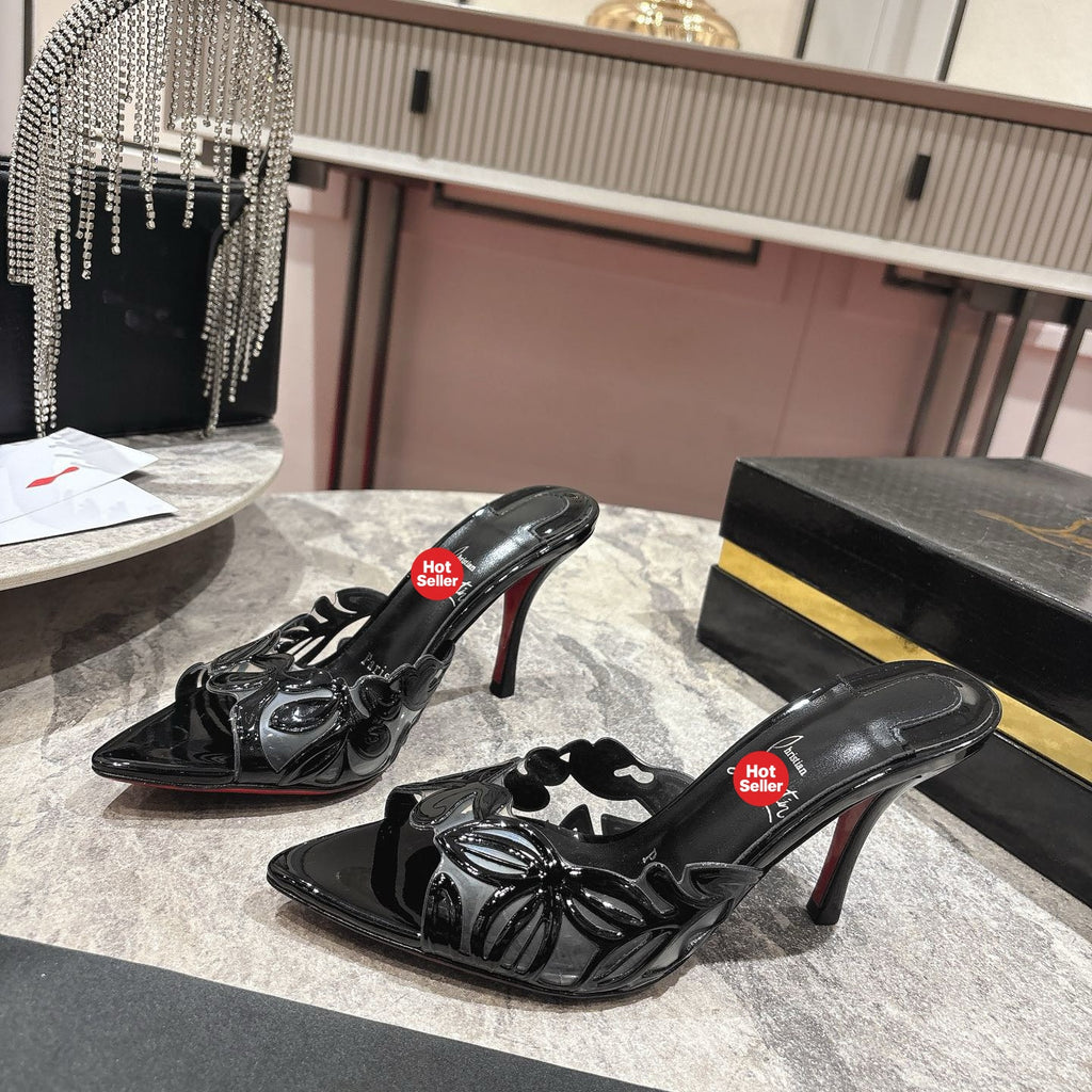 Black high-heeled mules with a stylish cutout design; 10cm heel.