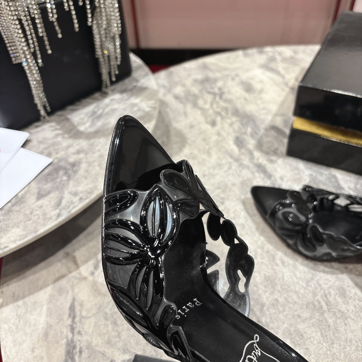 Black high-heeled mules with a stylish cutout design; 10cm heel.