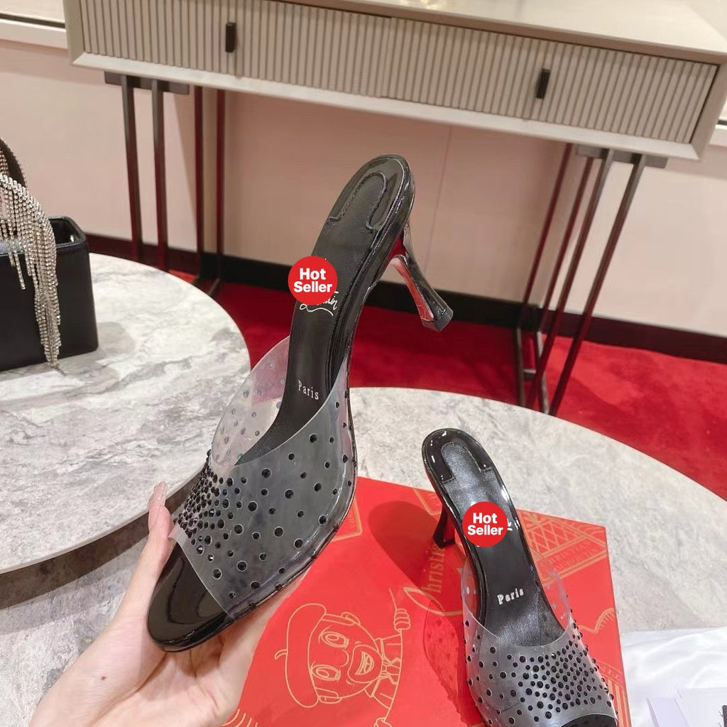 Black open-toe high-heeled mules with transparent strap detail; 8cm heel.
