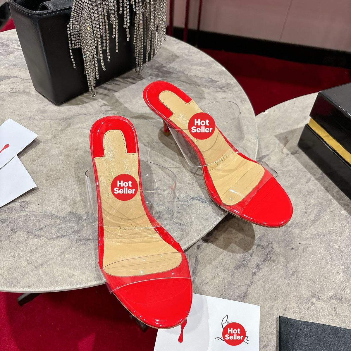 Red translucent high-heeled mules, 8.5cm heel.