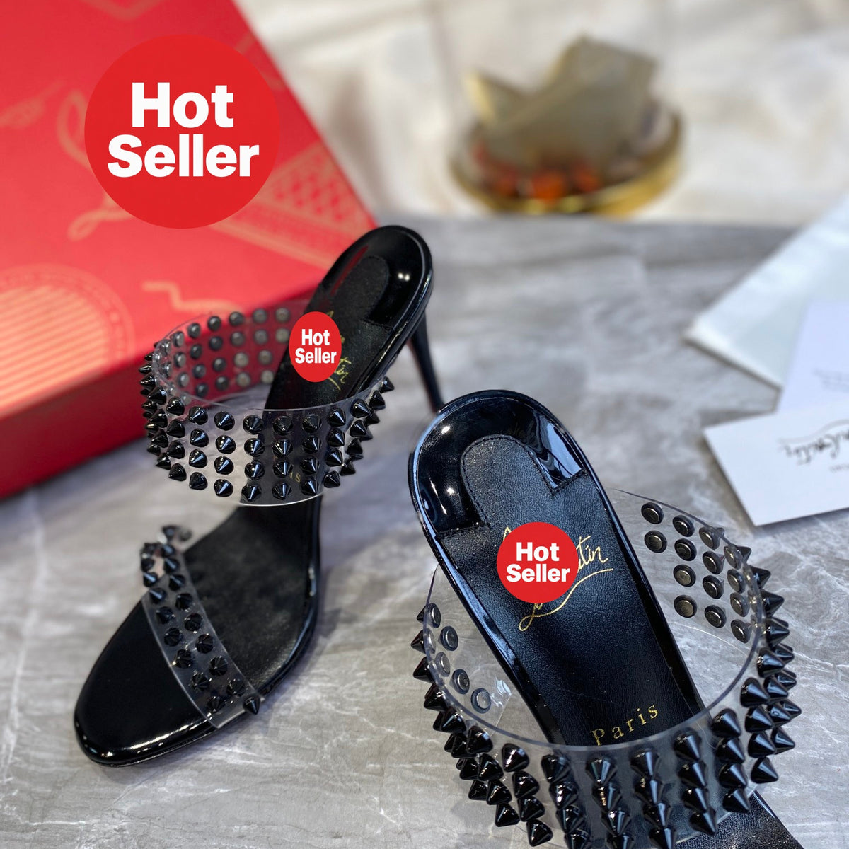 Black high-heeled mules with PVC straps and stud details; 10cm heel.