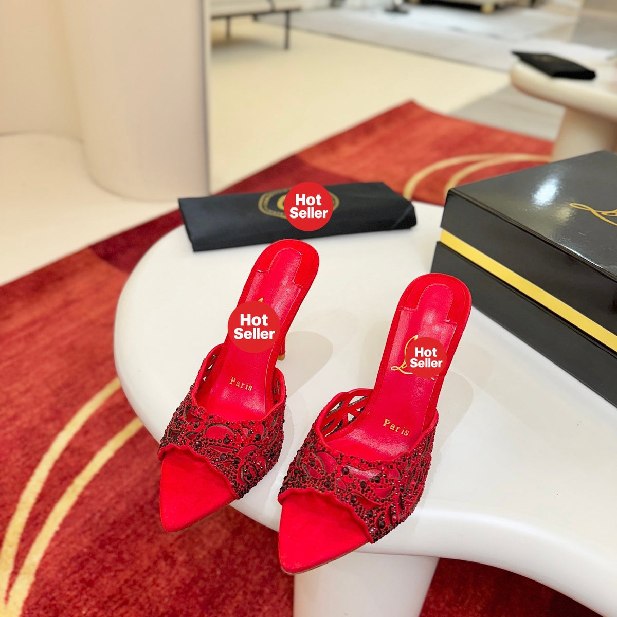 Red openwork high-heeled mules fully encrusted with rhinestones; 10cm heel.