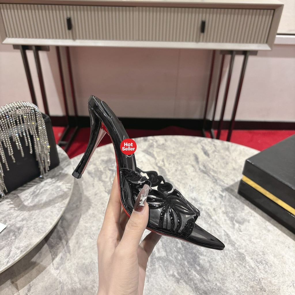 Black high-heeled mules with a stylish cutout design; 10cm heel.