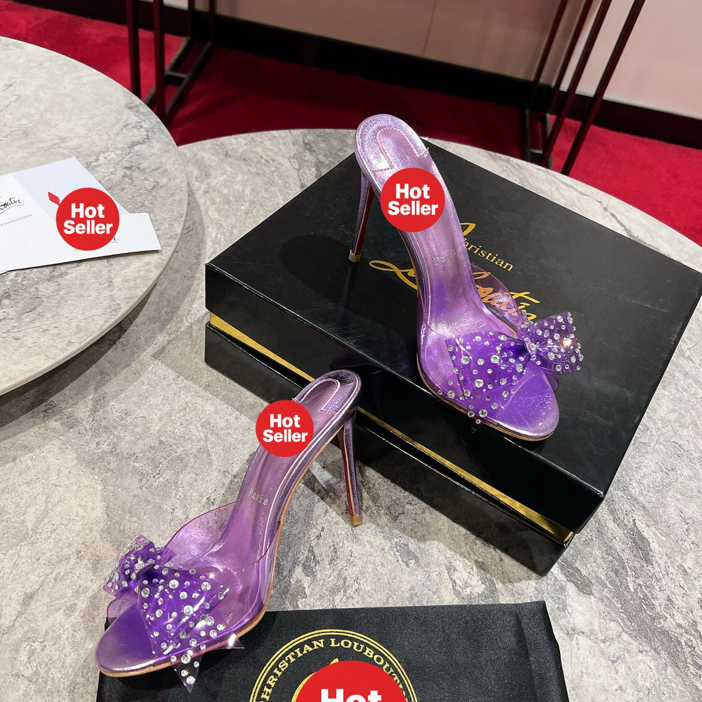 Purple high-heeled slides with a butterfly detail and transparent strap; 10cm heel.