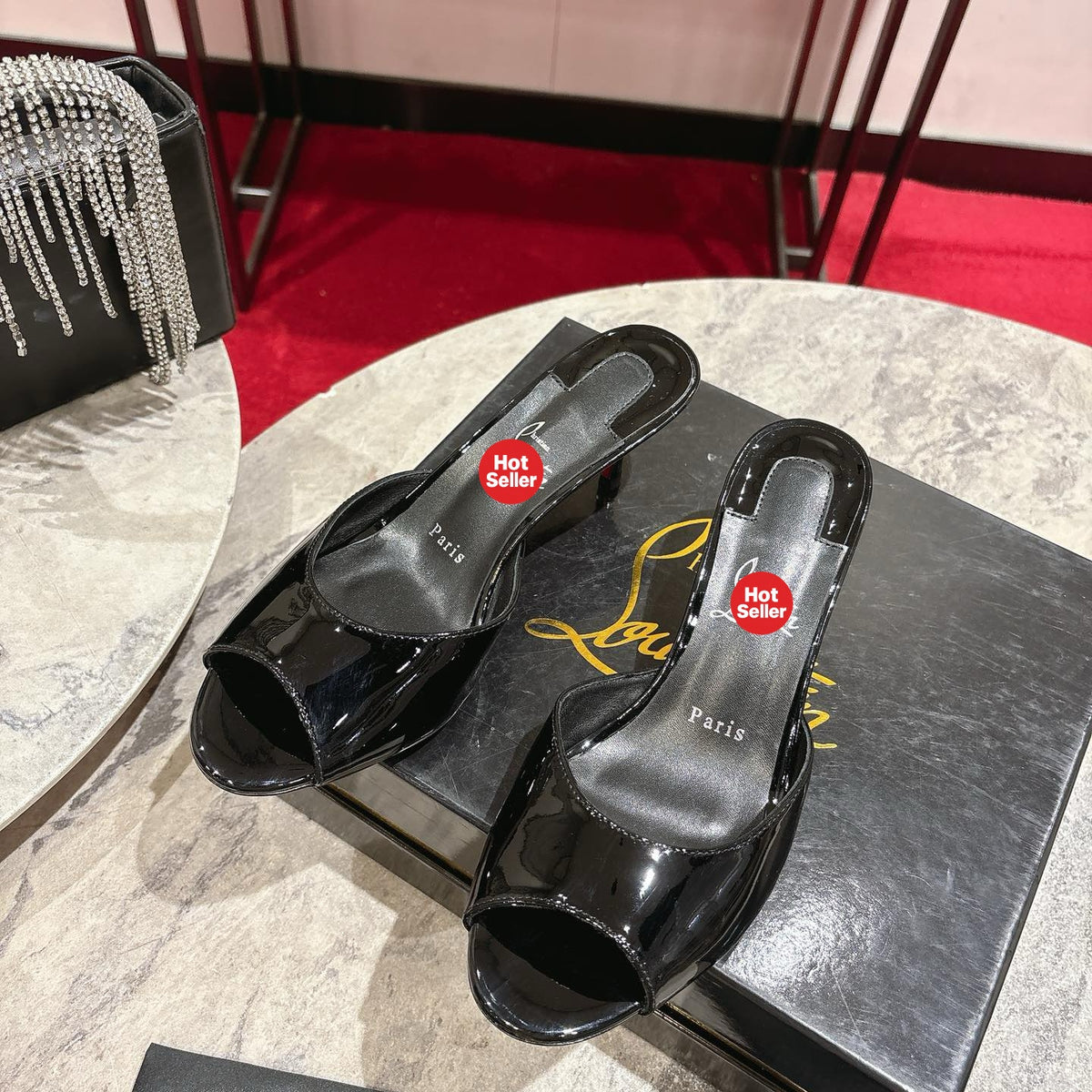 Black patent leather high-heeled mules, 8.5cm heel.