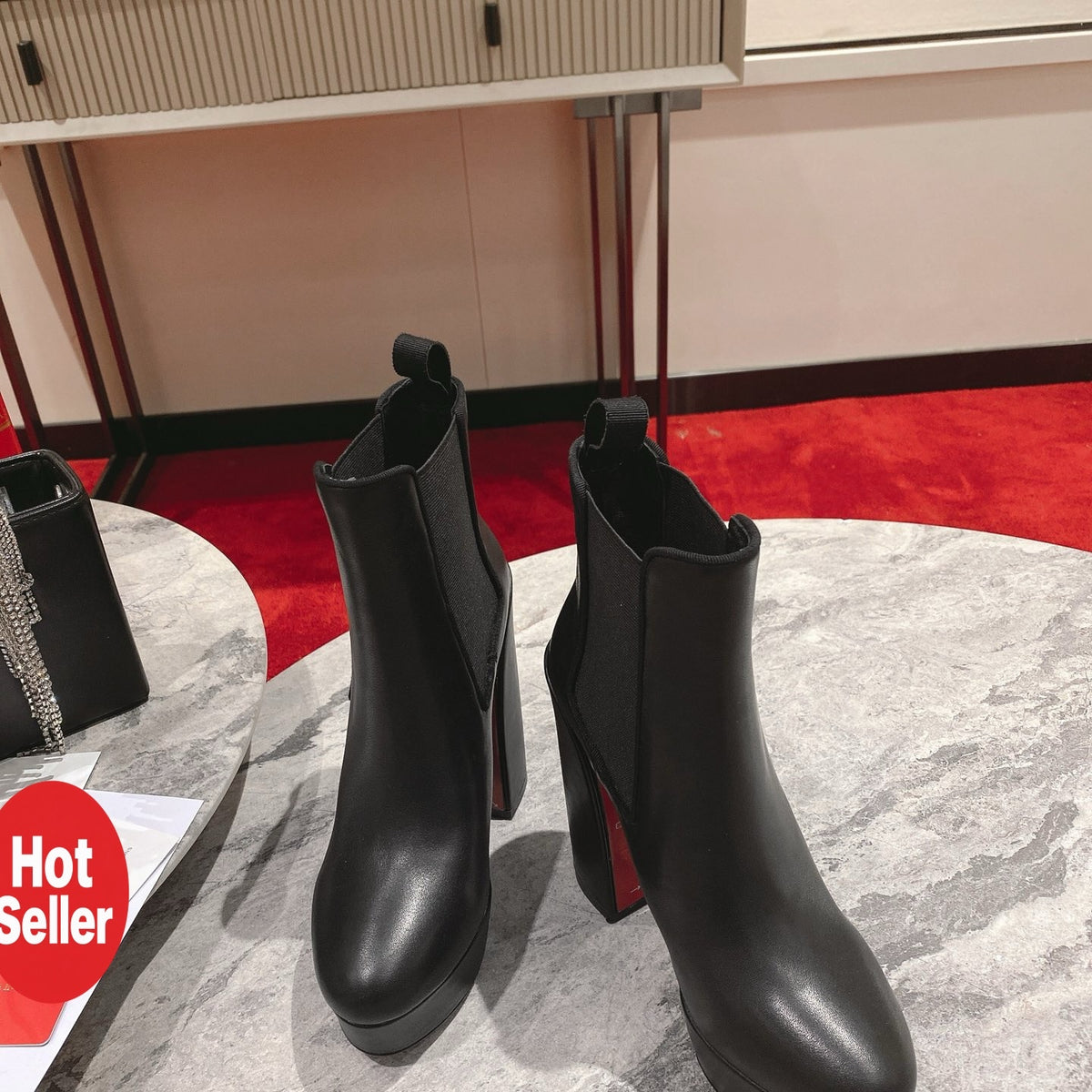 Black calfskin ankle boots with 13cm stiletto heels.