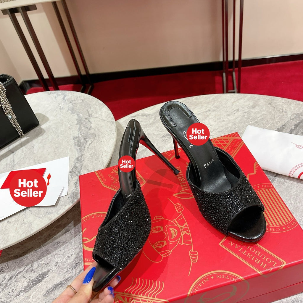 Black peep-toe high-heeled mules with rhinestone embellishment; 10cm heel.
