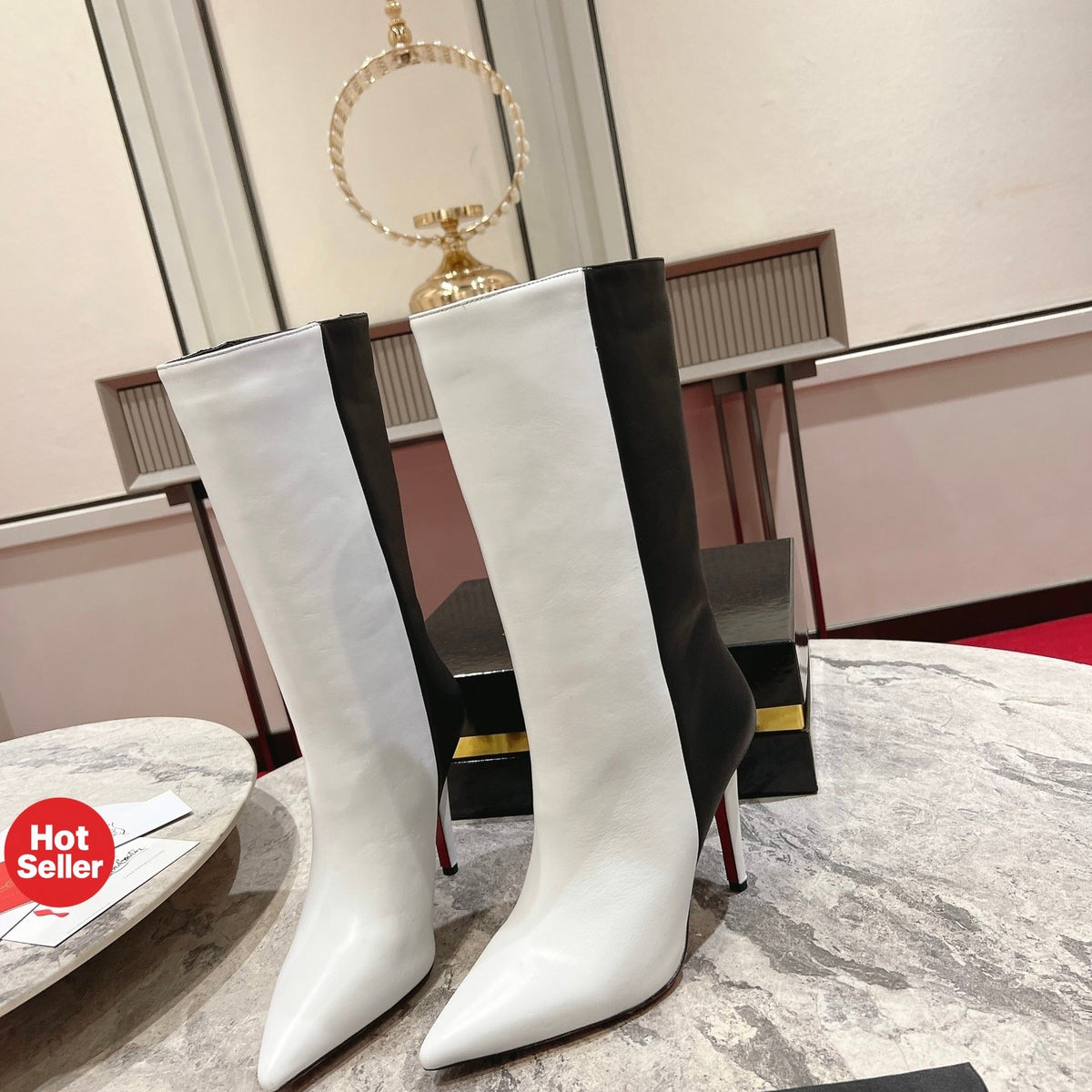 Paneled leather tall boots with a distinctive design; 10cm heel.