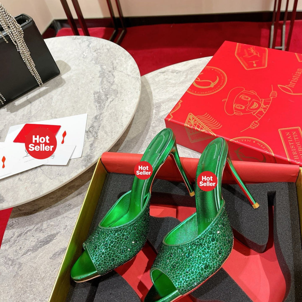 Green peep-toe high-heeled mules with rhinestone embellishment; 10cm heel.