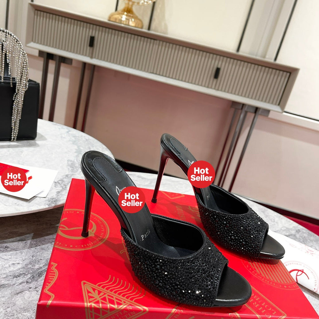 Black peep-toe high-heeled mules with rhinestone embellishment; 10cm heel.