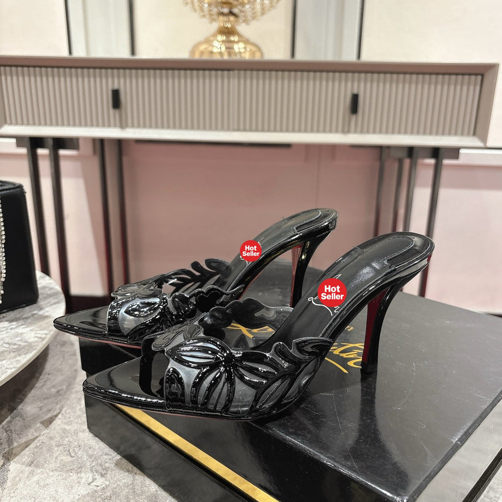 Black high-heeled mules with a stylish cutout design; 10cm heel.