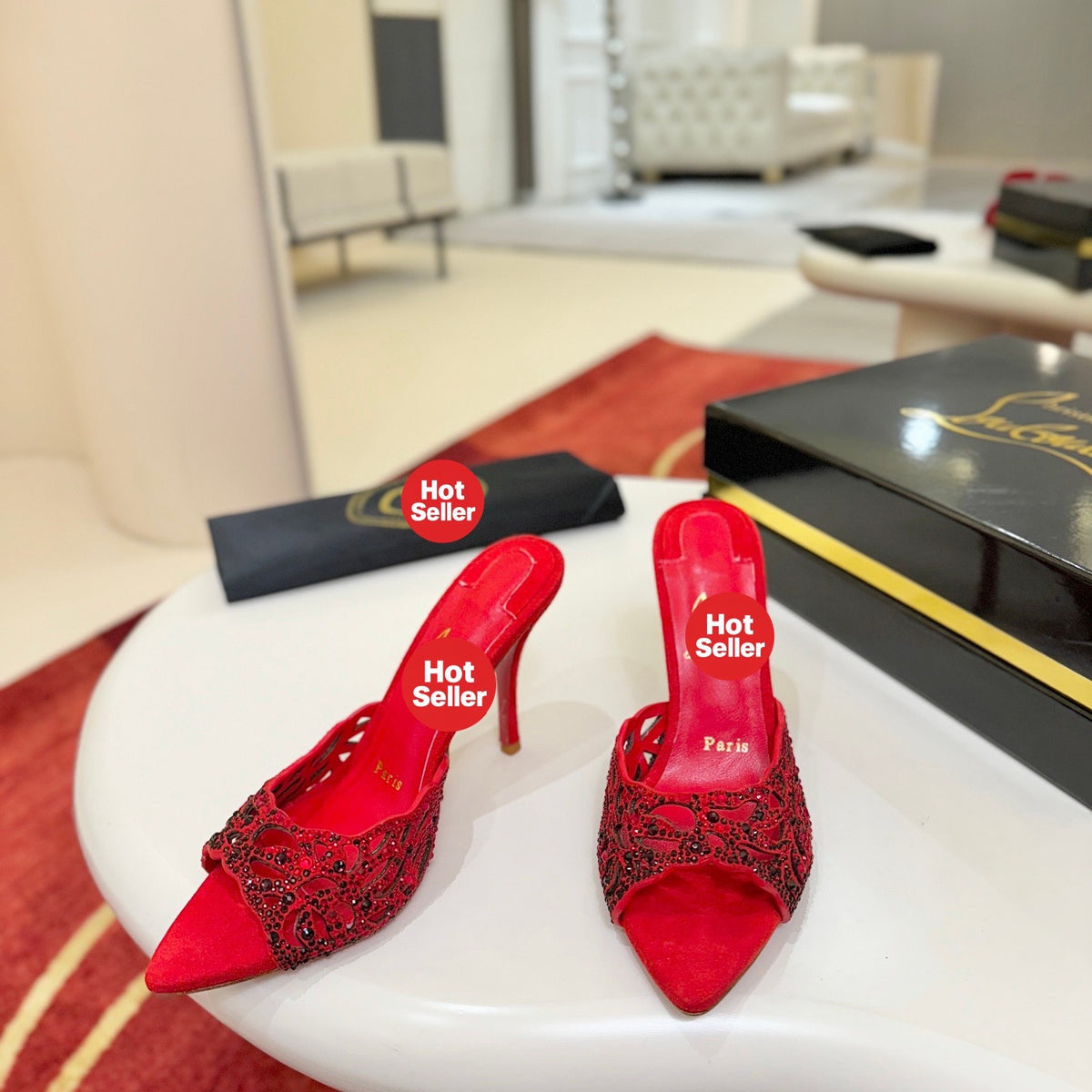 Red openwork high-heeled mules fully encrusted with rhinestones; 10cm heel.