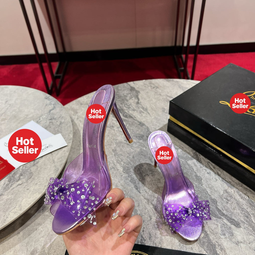 Purple high-heeled slides with a butterfly detail and transparent strap; 10cm heel.