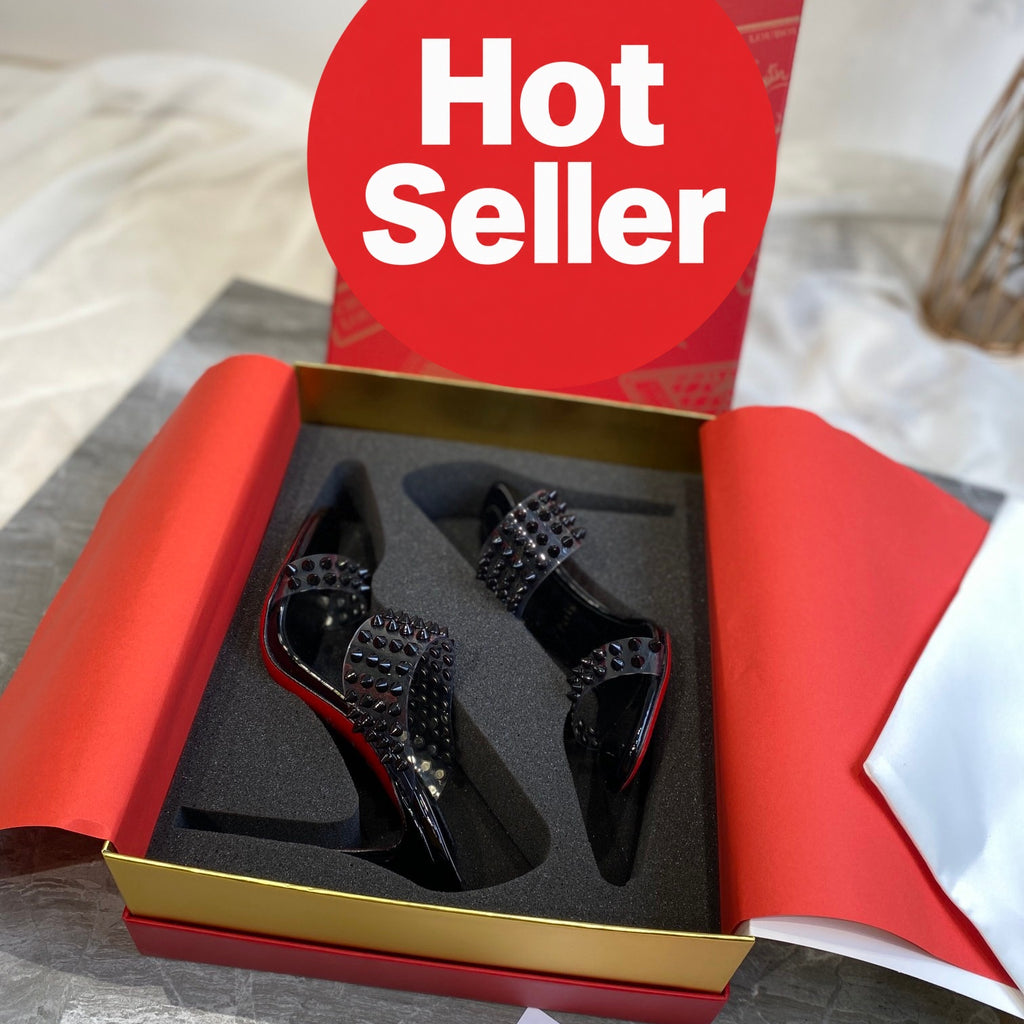 Black high-heeled mules with PVC straps and stud details; 10cm heel.