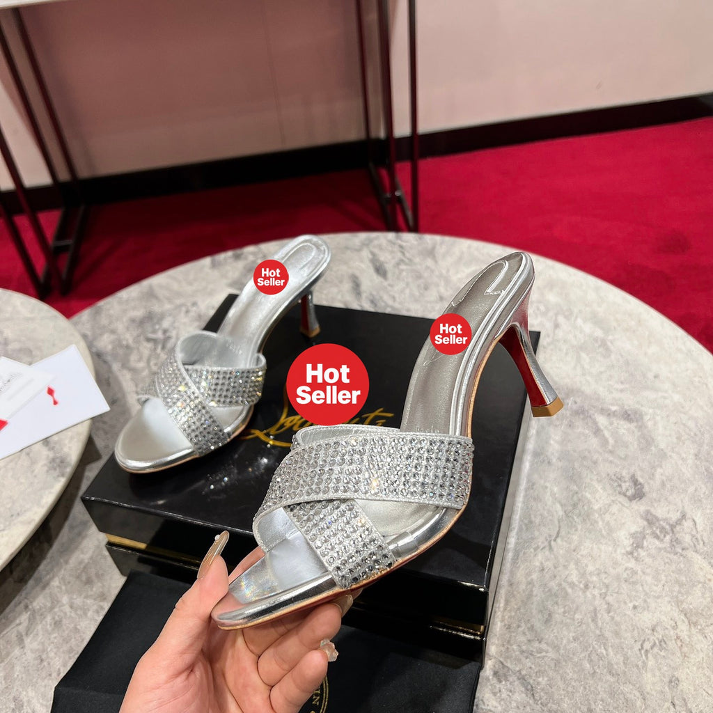 Silver peep-toe high-heeled mules with rhinestones; 8.5cm heel.