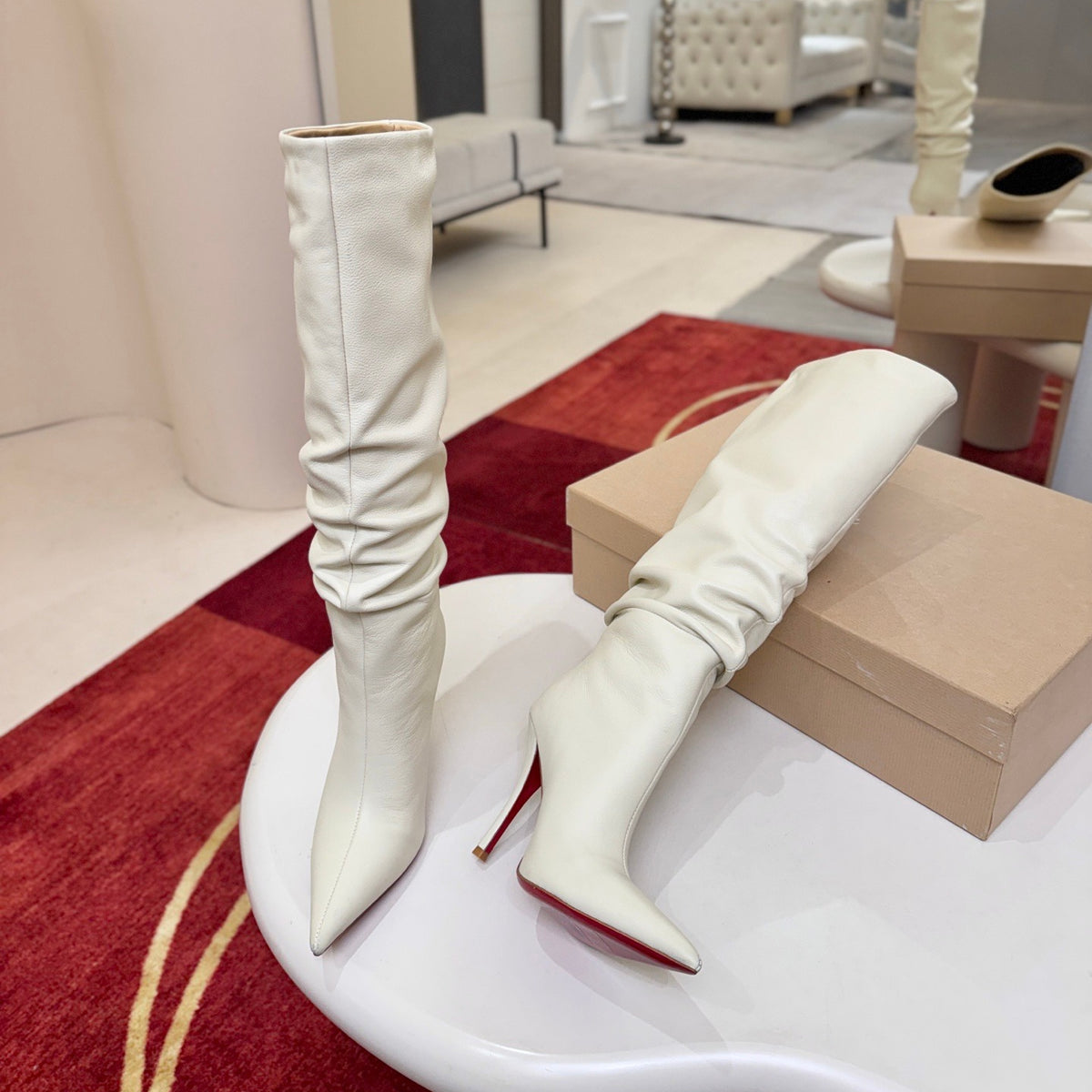 The boot's tapered silhouette creates a refined, modern look. This style features a 100mm stiletto heel.