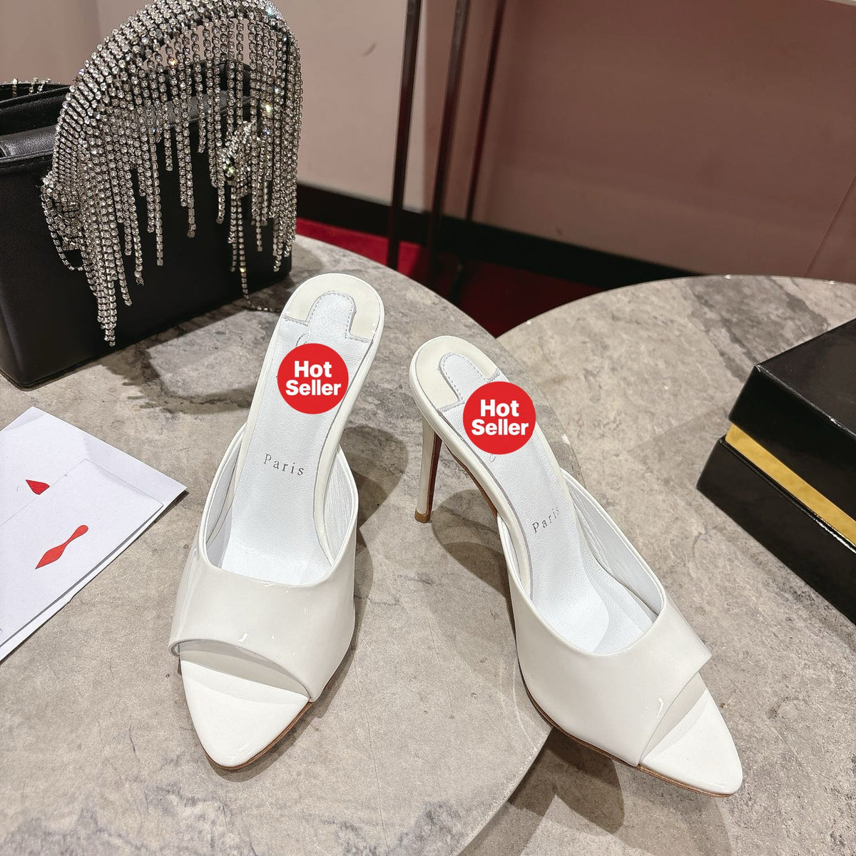 White pointed-toe patent leather high-heeled mules, 10cm heel.