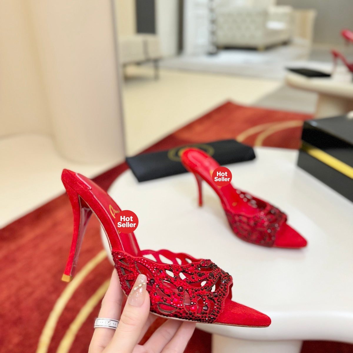 Red openwork high-heeled mules fully encrusted with rhinestones; 10cm heel.