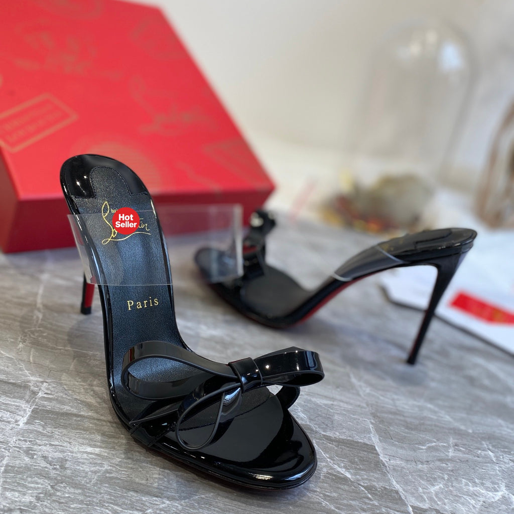 Black high-heeled mules with butterfly-shaped transparent detail; 10cm heel.