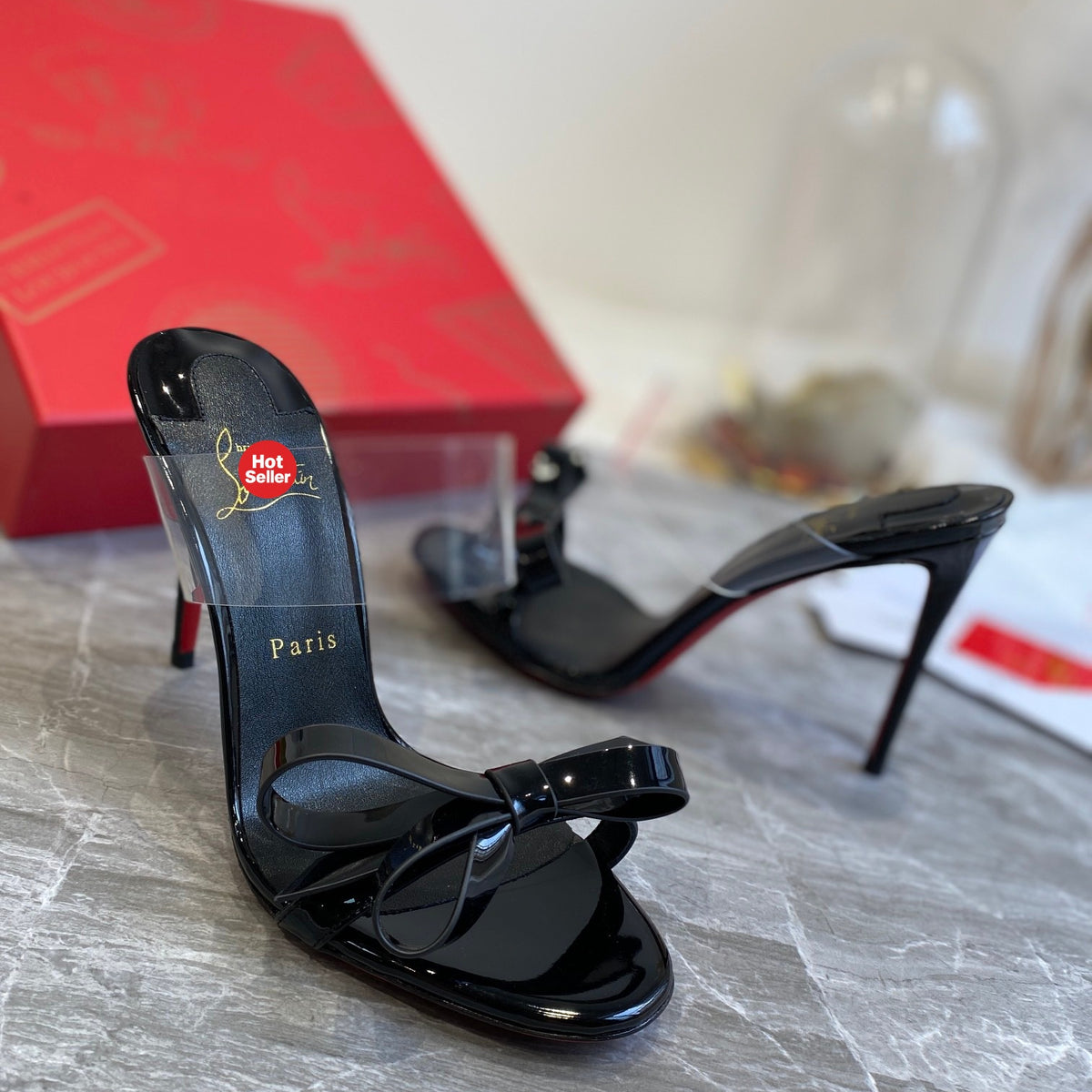 Black high-heeled mules with butterfly-shaped transparent detail; 10cm heel.