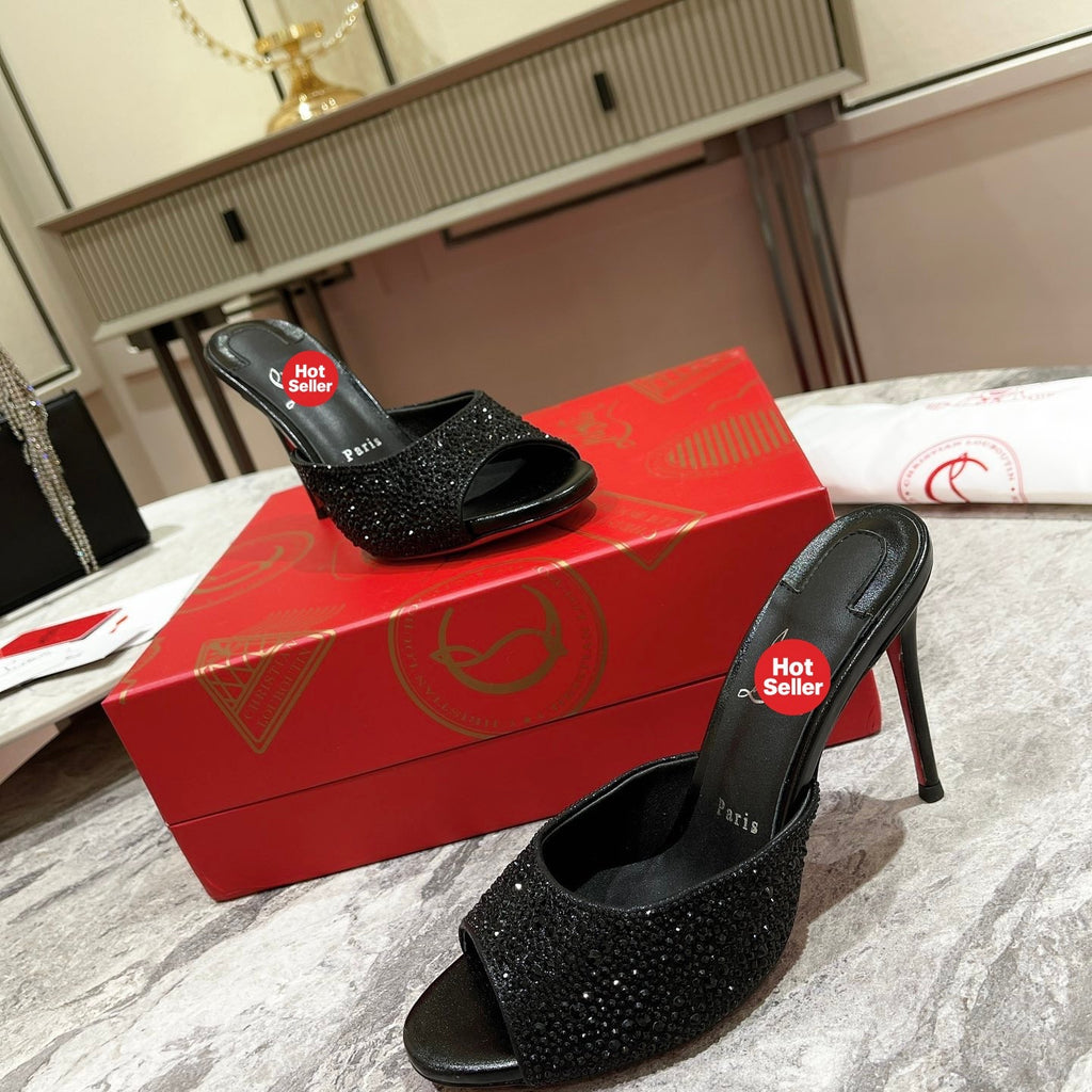 Black peep-toe high-heeled mules with rhinestone embellishment; 10cm heel.