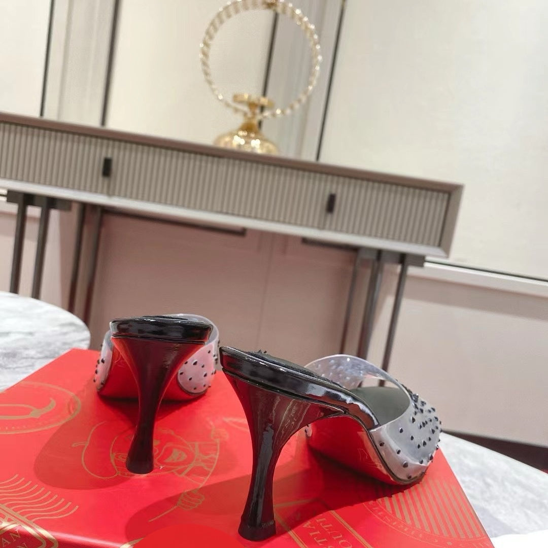 Black open-toe high-heeled mules with transparent strap detail; 8cm heel.