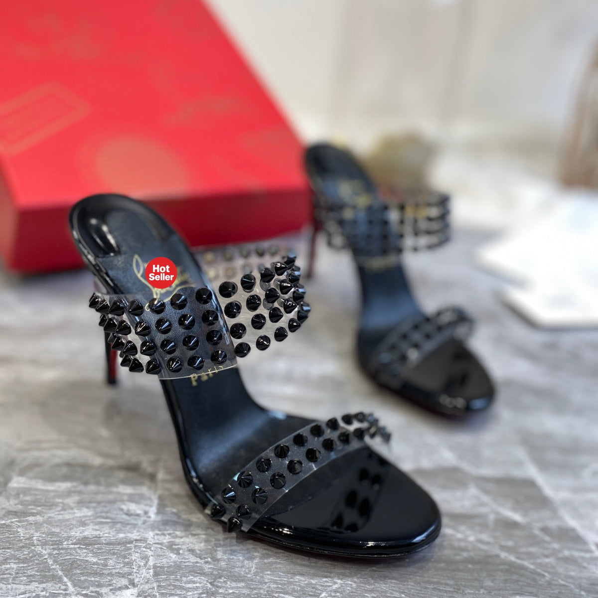 Black high-heeled mules with PVC straps and stud details; 10cm heel.