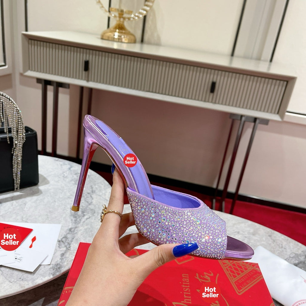 Purple peep-toe high-heeled mules with rhinestone embellishment; 10cm heel.