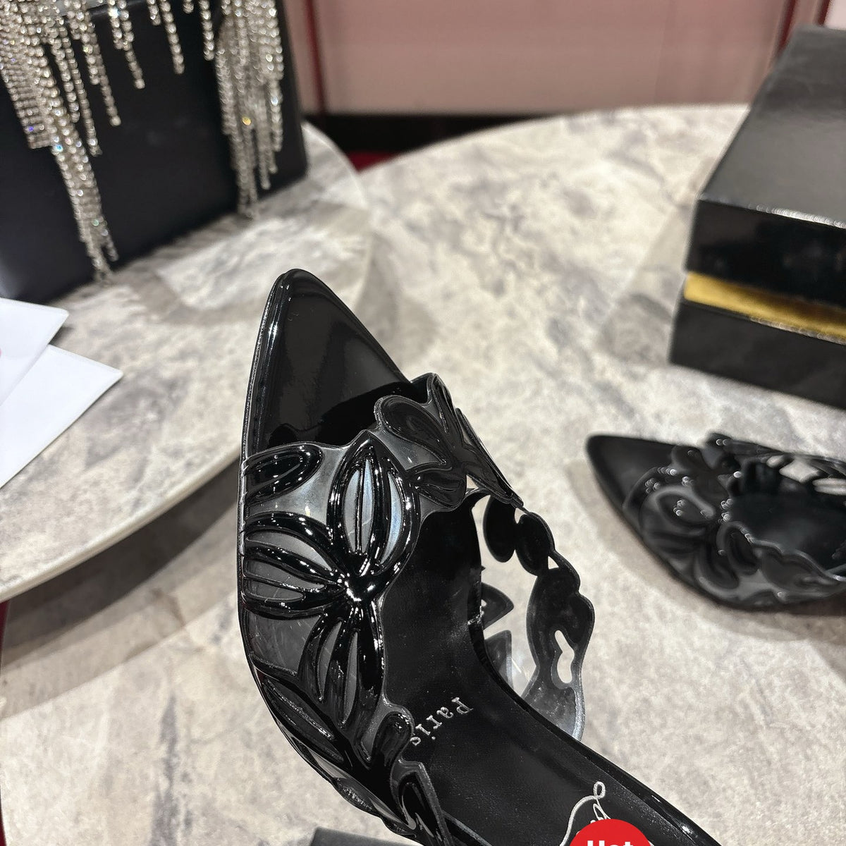 Black high-heeled mules with a stylish cutout design; 10cm heel.