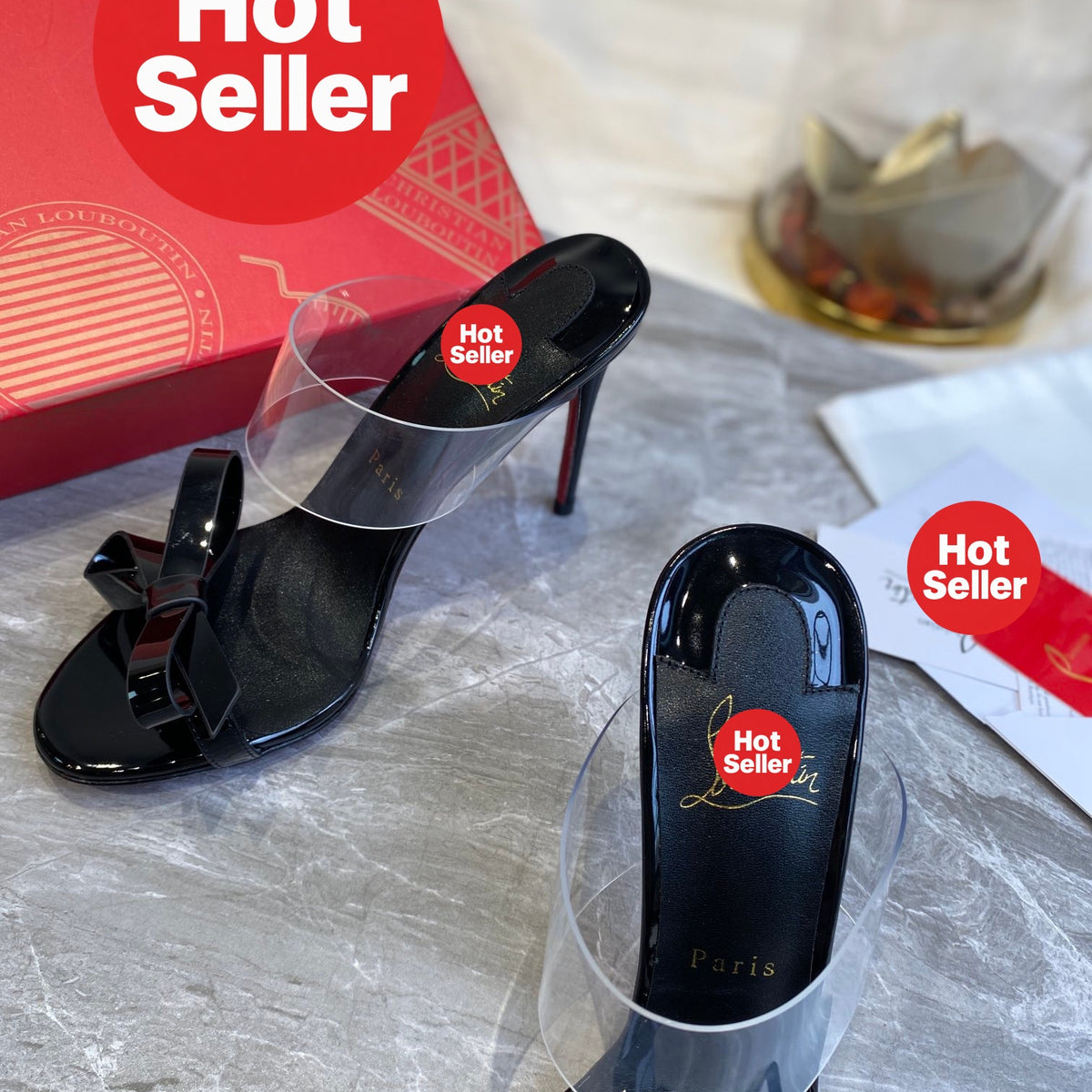 Black high-heeled mules with butterfly-shaped transparent detail; 10cm heel.