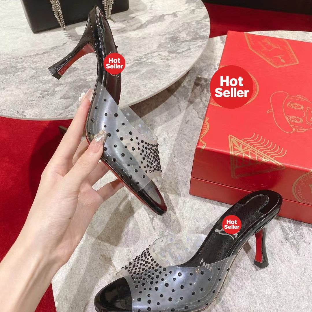 Black open-toe high-heeled mules with transparent strap detail; 8cm heel.