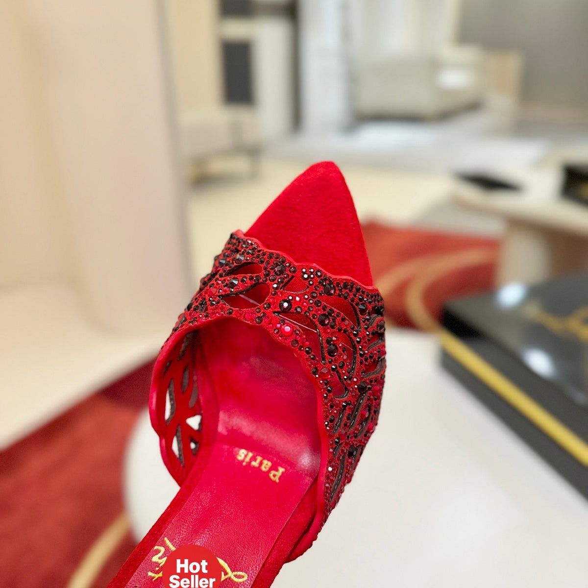 Red openwork high-heeled mules fully encrusted with rhinestones; 10cm heel.