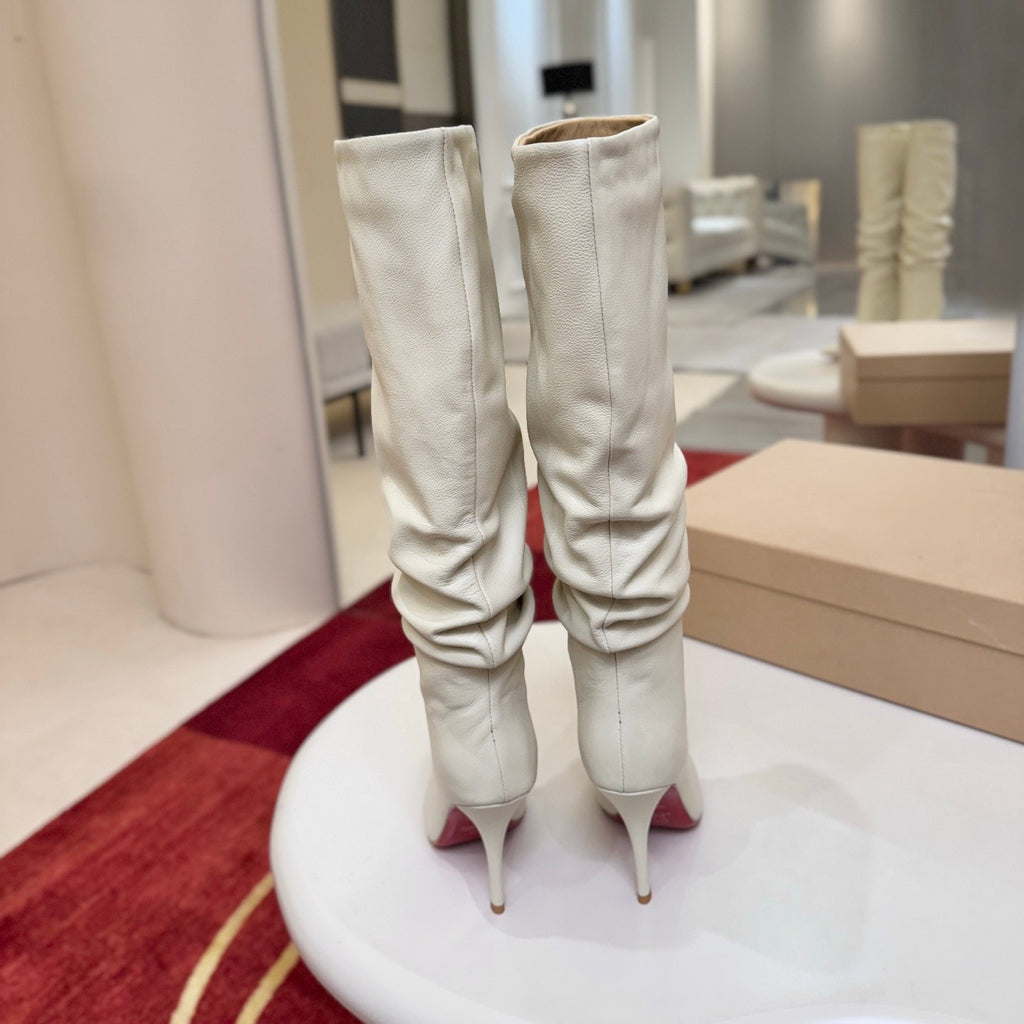 The boot's tapered silhouette creates a refined, modern look. This style features a 100mm stiletto heel.