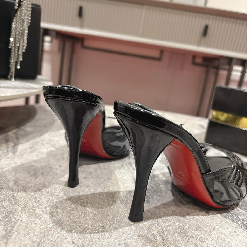 Black high-heeled mules with a stylish cutout design; 10cm heel.